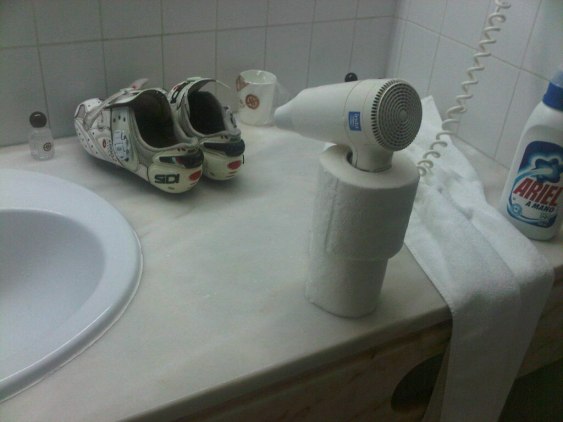 This is how I dry my shoes in just a few minutes. Notice the double effect of the paper-roll, both as a stand as well as holding down the "on" button on the dryer. 